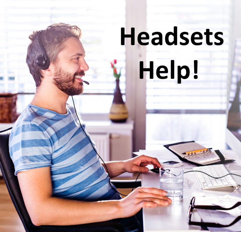 man using headset for proper home office computer ergonomic setup