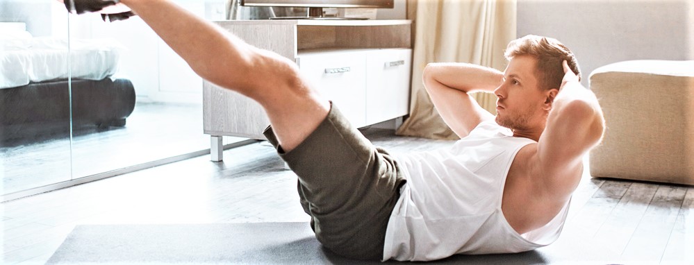 man working out at home crunches